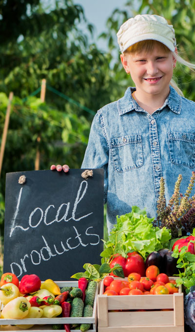 Young girl selling produce at a farmer’s market Young girl selling produce at a farmer's market
