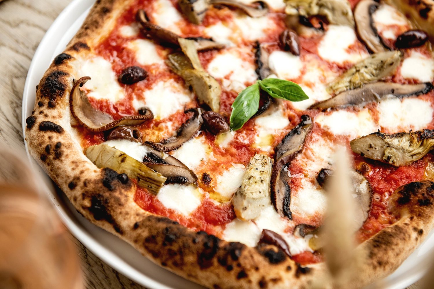 Cantuccio A close-up picture of an Italian wood-fired pizza filled with toppings
