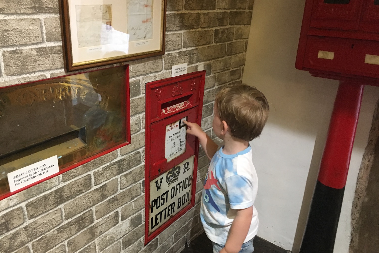 cranbrook-museum3 A young boy touching a red post office letter box