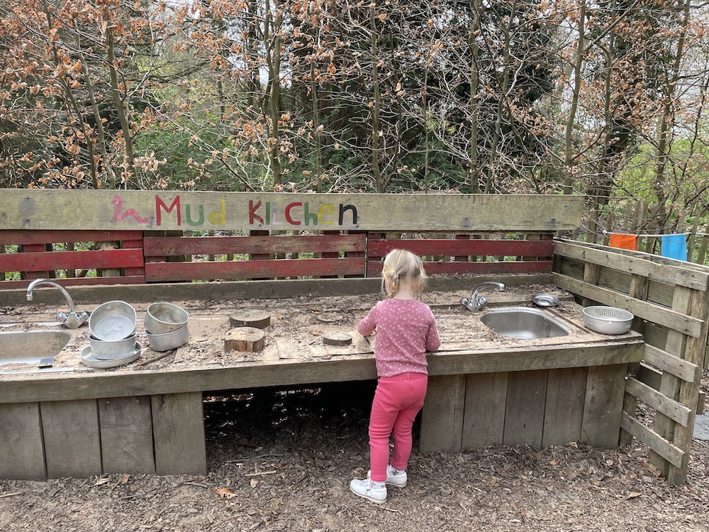 scotney-castle-3 A young child playing with a mud kitchen outside