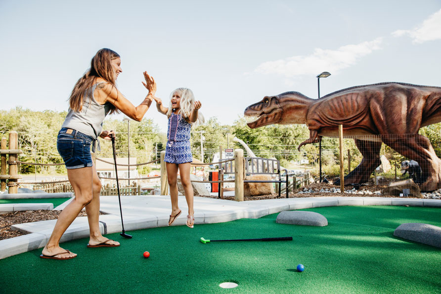 Family-playing-mini-golf Family playing mini golf