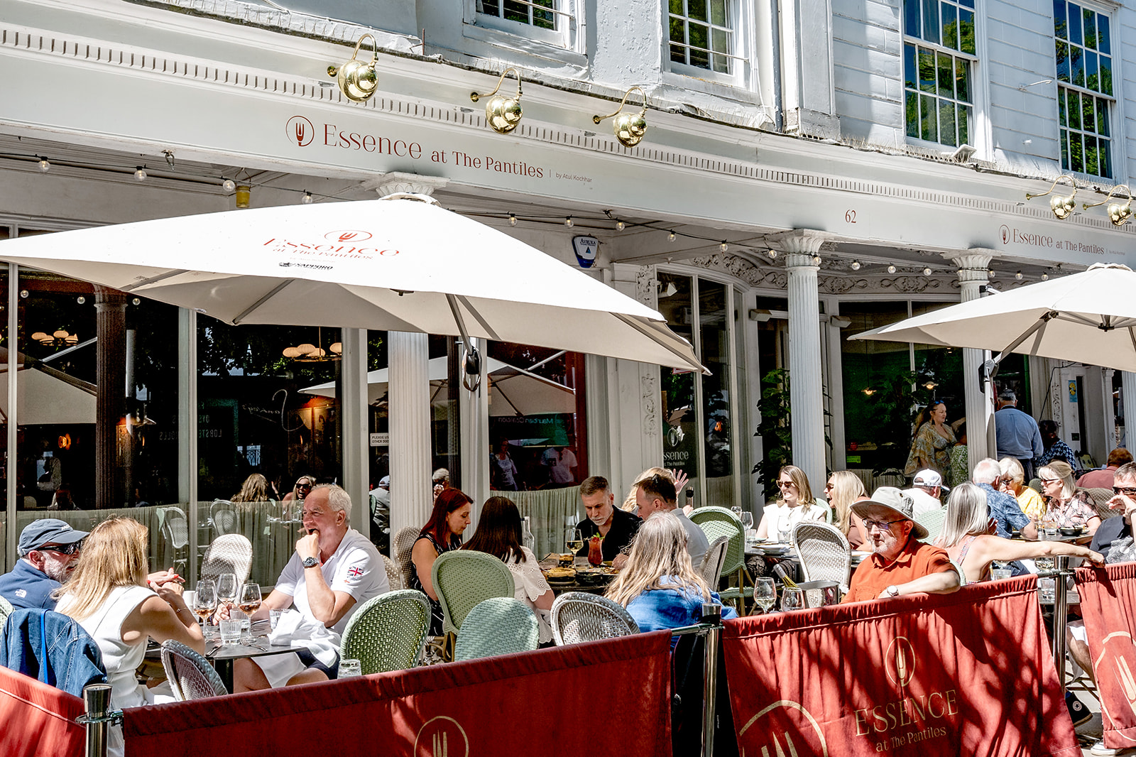 Front of restaurant with outdoor seating under umbrellas