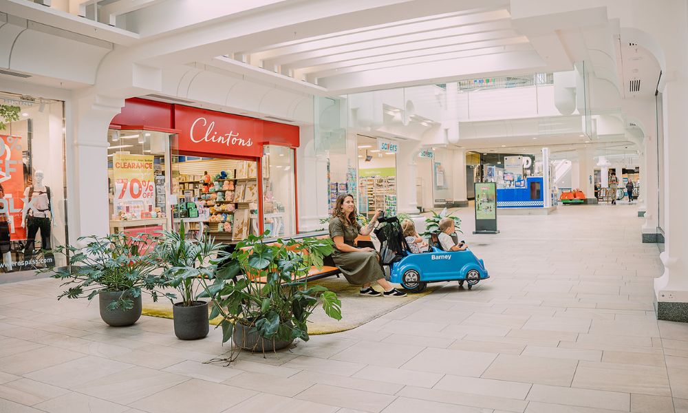 Family on bench seat in shopping centre