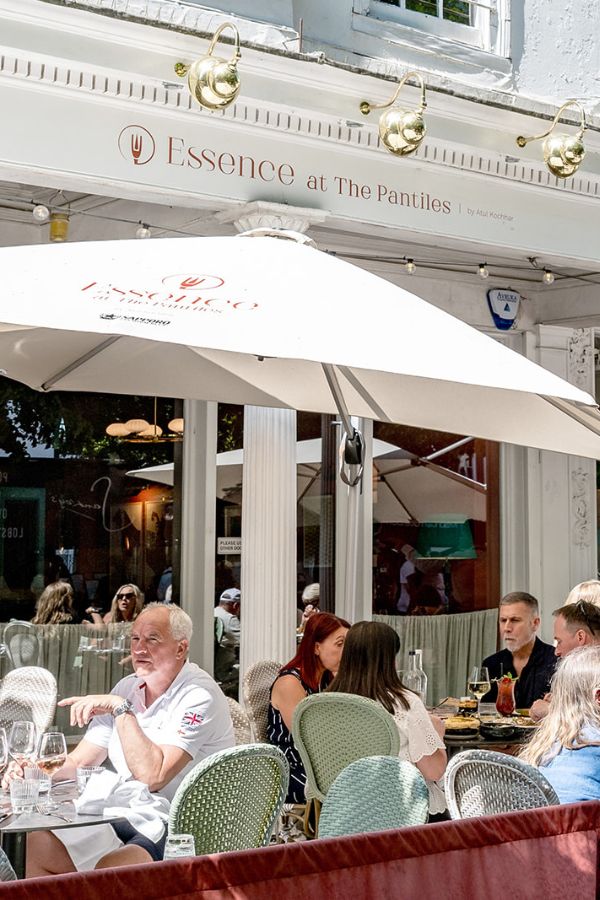 Front of restaurant with outdoor seating under umbrellas